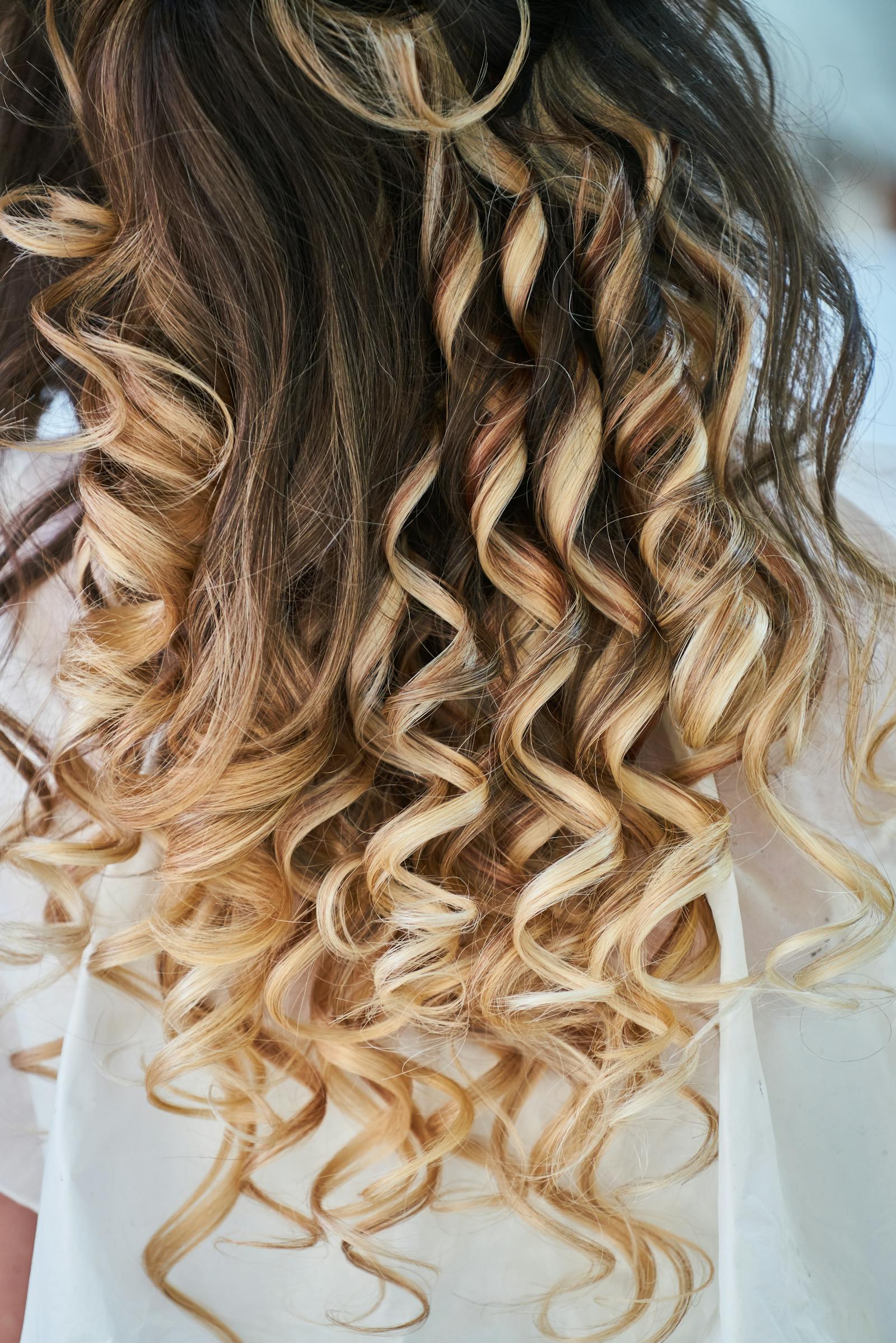 Cascading spiral blonde curls — finished perm